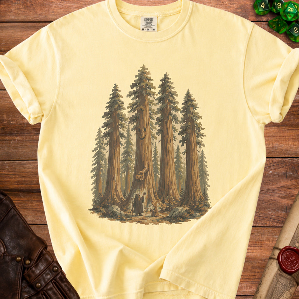 Yellow t-shirt with graphic of whimsical forest creatures and sequoia trees.
