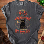 Dark grey t-shirt with black cat graphic and text "I'VE TASTED 9-5 AND I'VE TASTED UNEMPLOYMENT I RECOMMEND NOT BEING BORN".