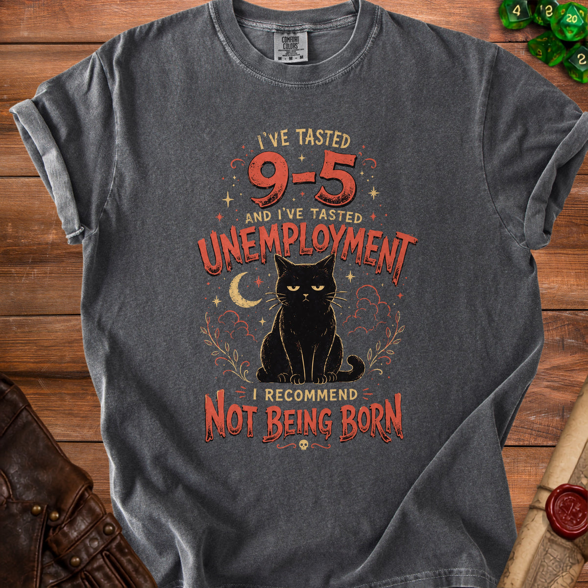 Dark grey t-shirt with black cat graphic and text "I'VE TASTED 9-5 AND I'VE TASTED UNEMPLOYMENT I RECOMMEND NOT BEING BORN".