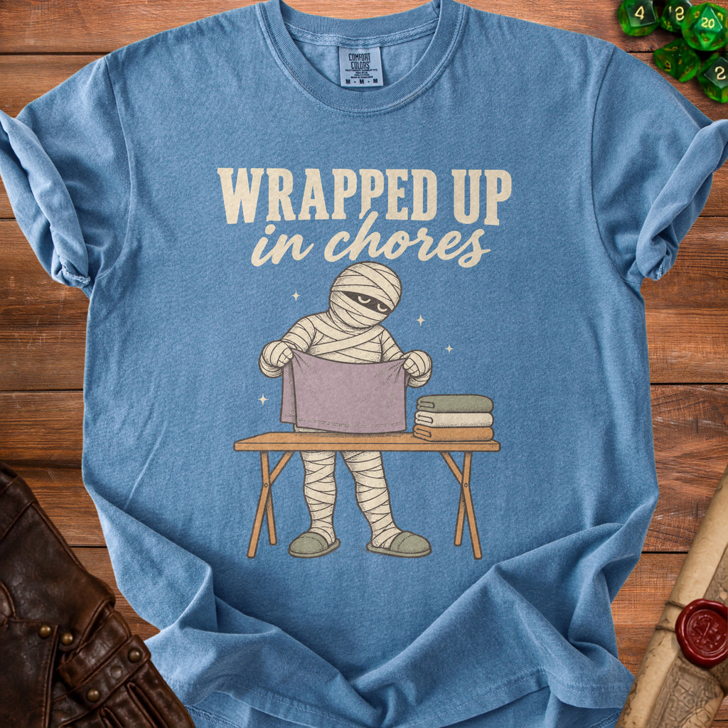 Blue t-shirt with mummy graphic and "WRAPPED UP in chores" text.