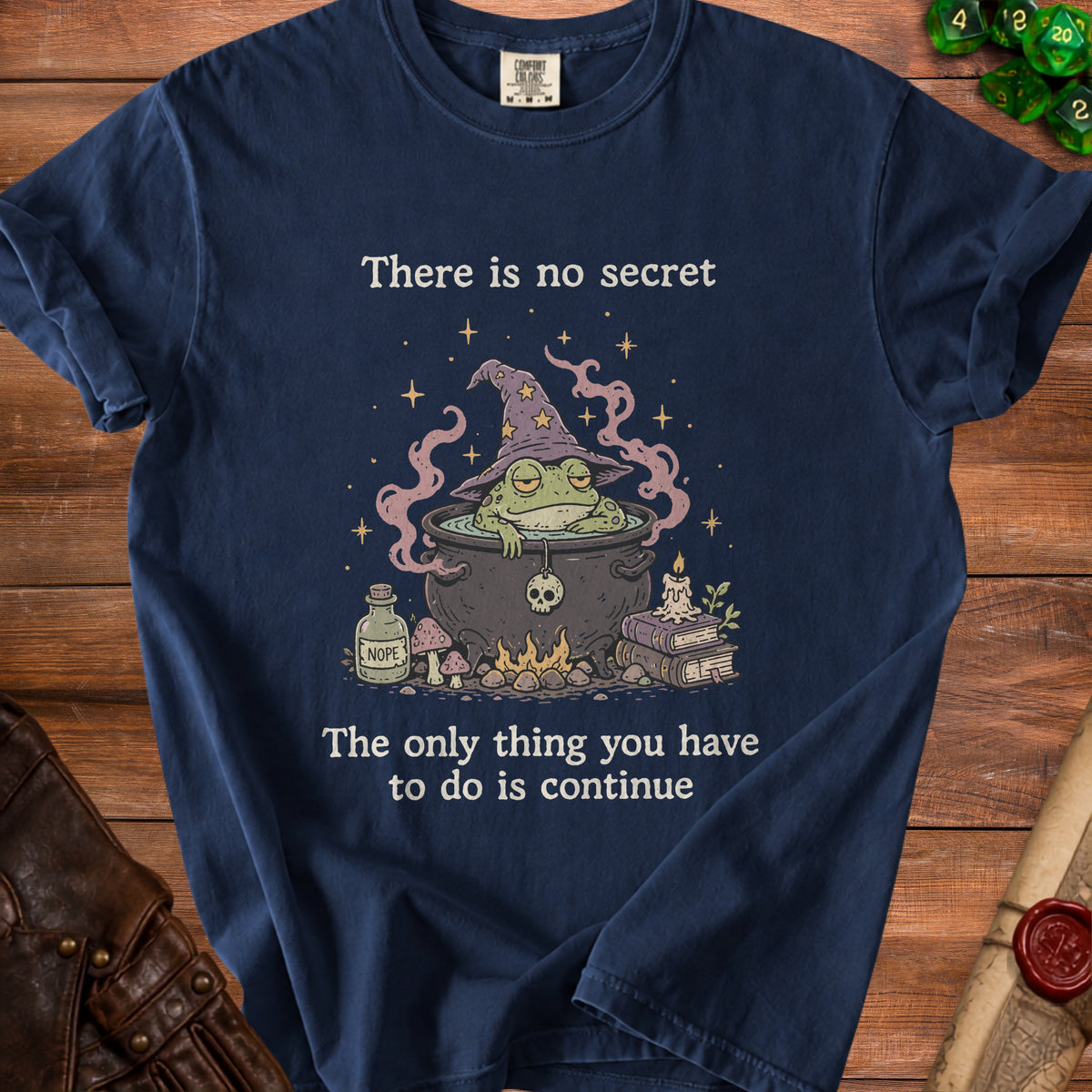 Navy t-shirt with wizard frog graphic and text: "There is no secret. The only thing you have to do is continue."