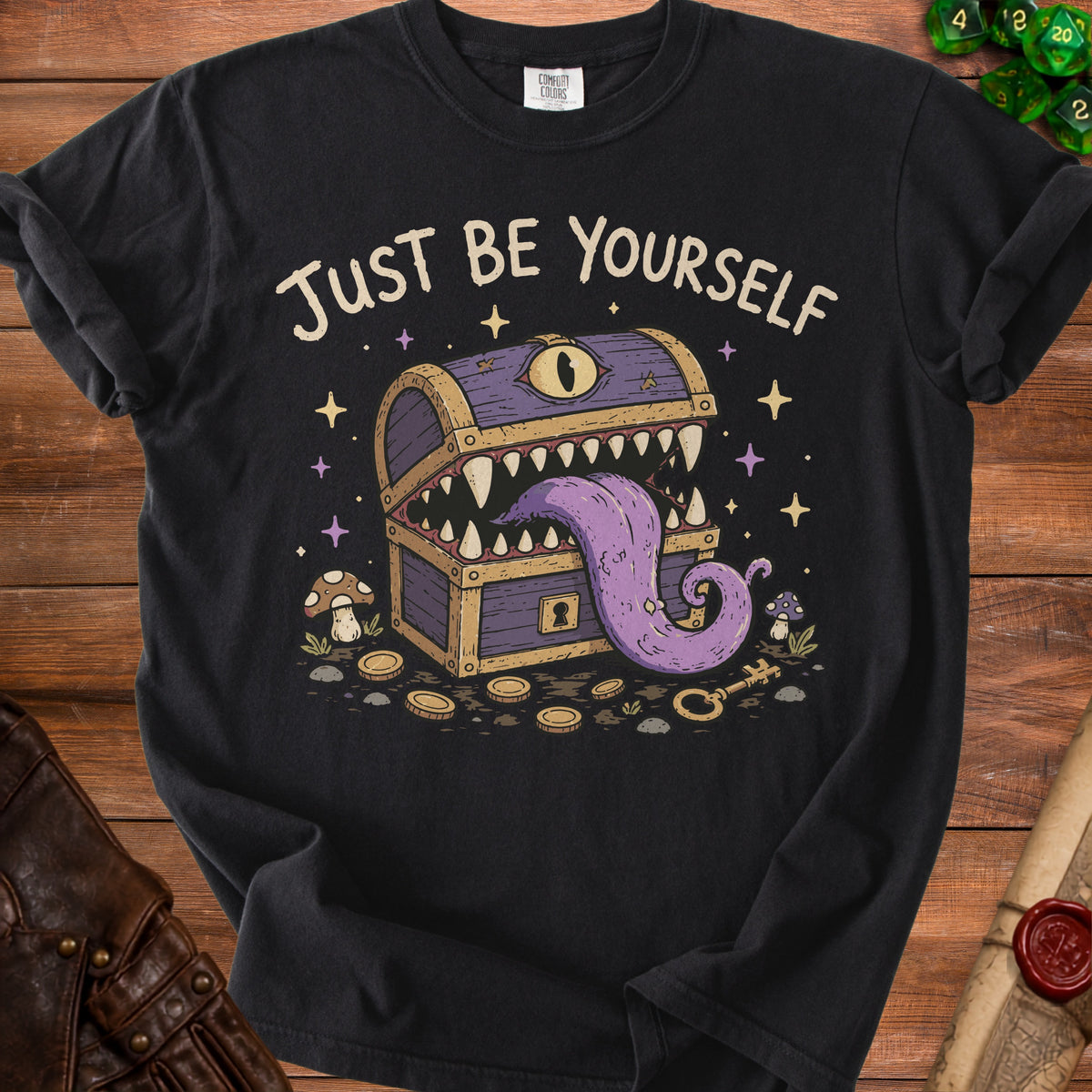 Black t-shirt with "Just Be Yourself" text and a monster treasure chest graphic.