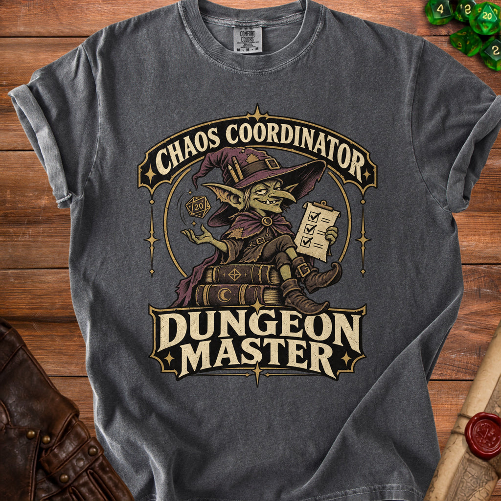 Charcoal gray t-shirt featuring a fantasy graphic with a goblin wizard, the text Chaos Coordinator Dungeon Master, and tabletop gaming accessories.