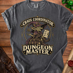 Charcoal gray t-shirt featuring a fantasy graphic with a goblin wizard, the text Chaos Coordinator Dungeon Master, and tabletop gaming accessories.