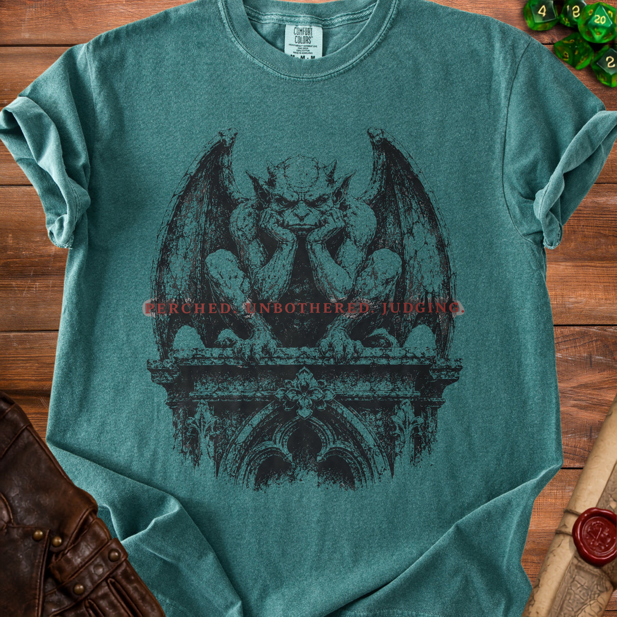 Teal t-shirt with a gargoyle graphic and "CERCHED UNBOTHERED JUDGING" text.