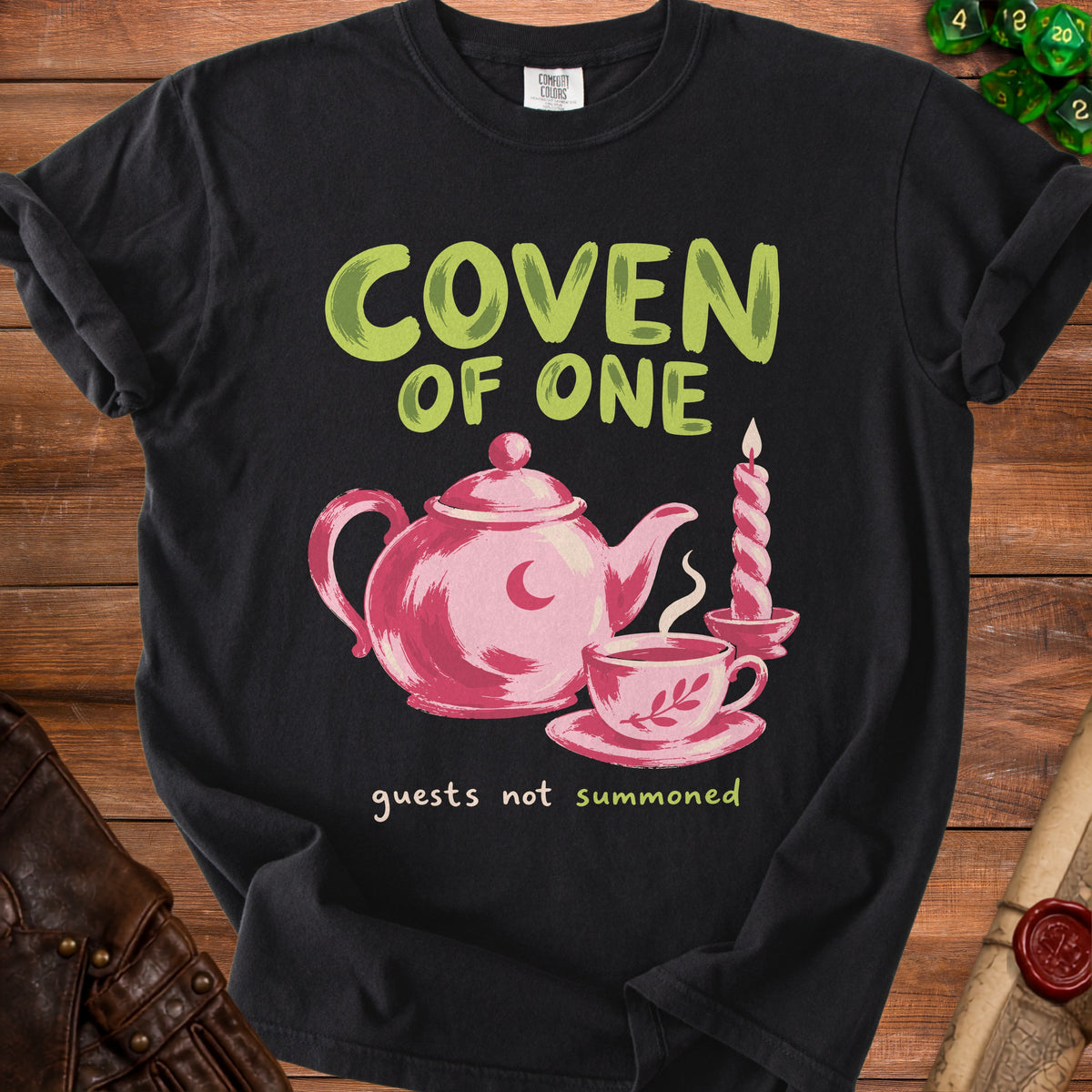 Black t-shirt with "Coven of One" and tea set graphic.