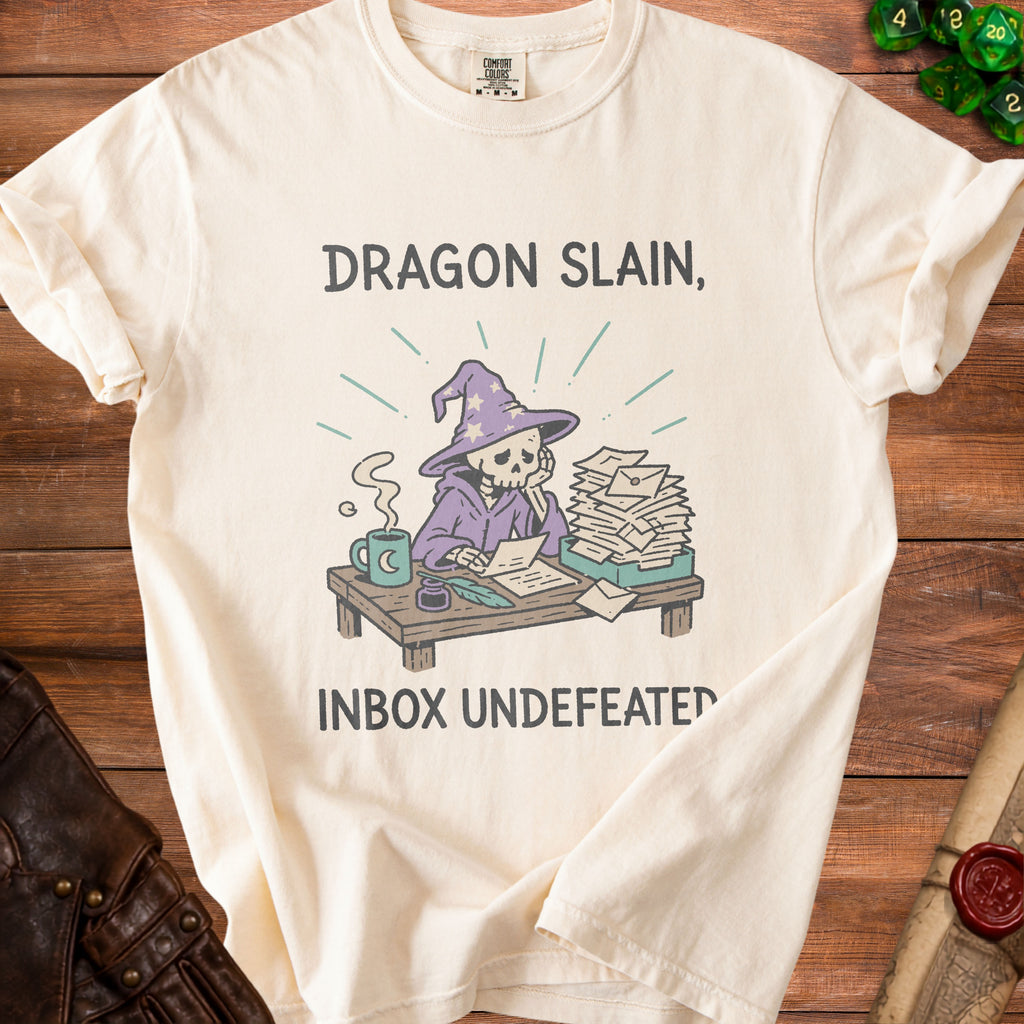 Cream t-shirt with graphic of skeleton wizard and text "Dragon Slain, Inbox Undefeated."