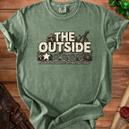 Green t-shirt with "The Outside" text, stars, and gaming dice.