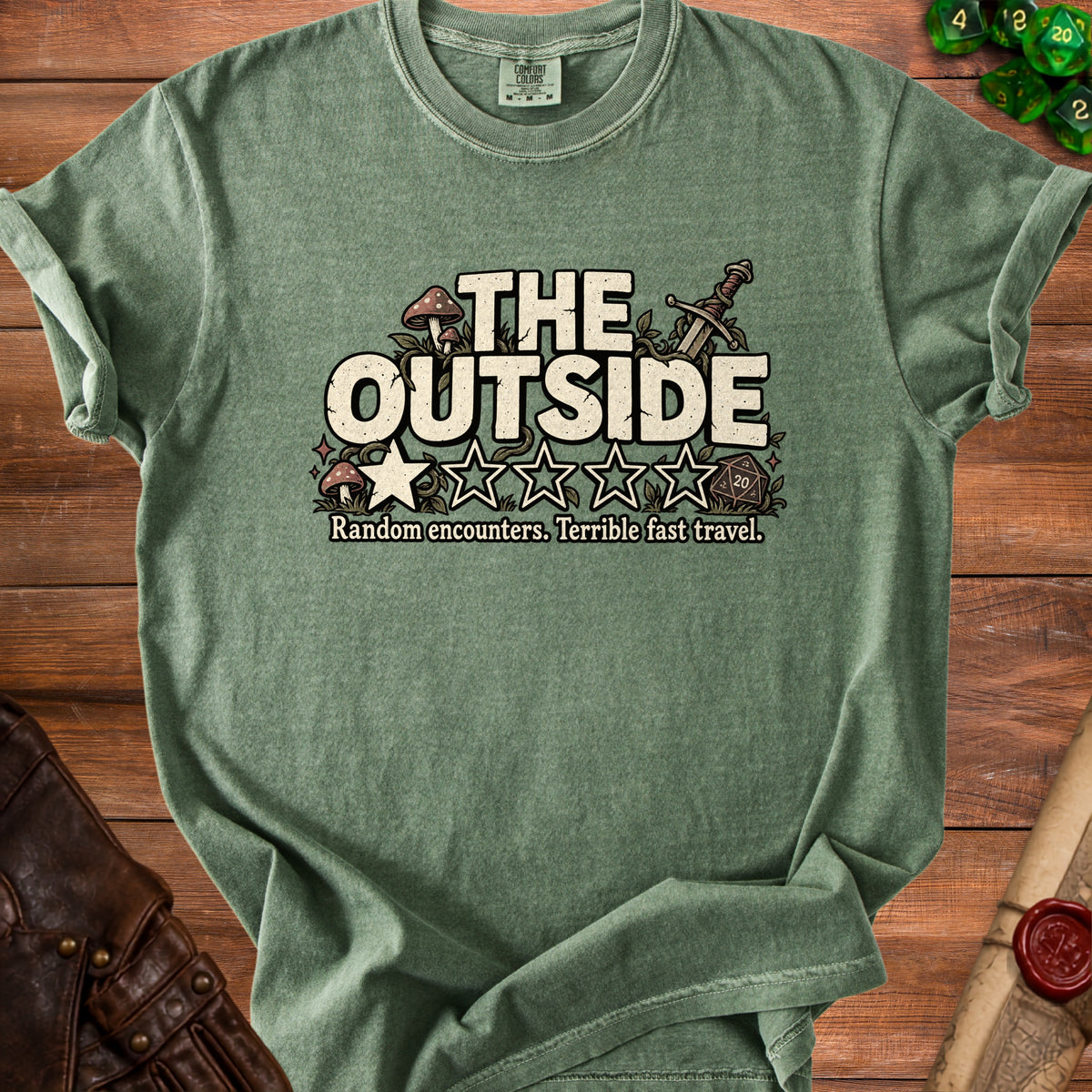 Green t-shirt with "The Outside" text, stars, and gaming dice.