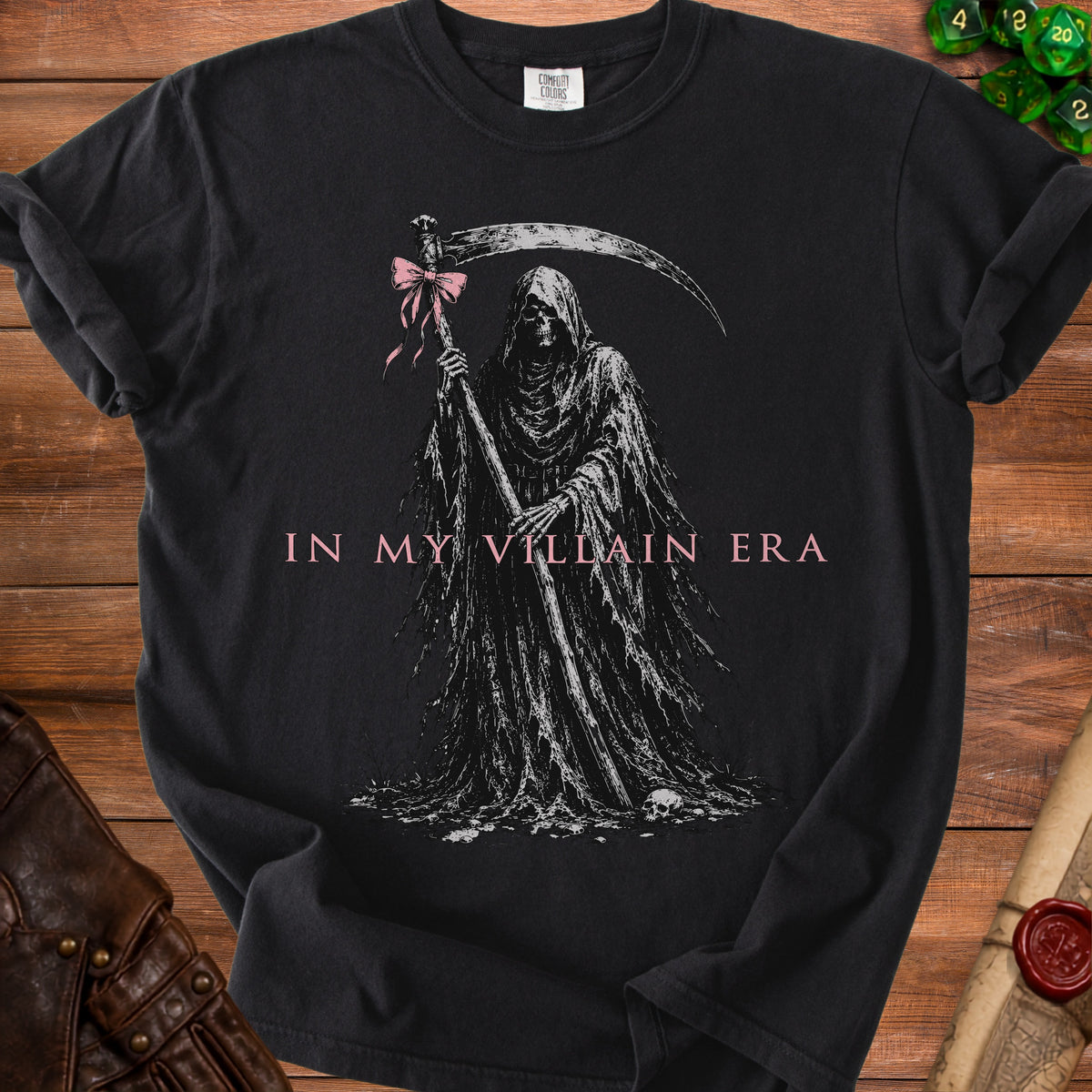 Grim Reaper with a pink bow holding a scythe, text "IN MY VILLAIN ERA".