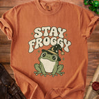 Orange t-shirt with "STAY FROGGY" text and a cartoon frog wearing a wizard hat.