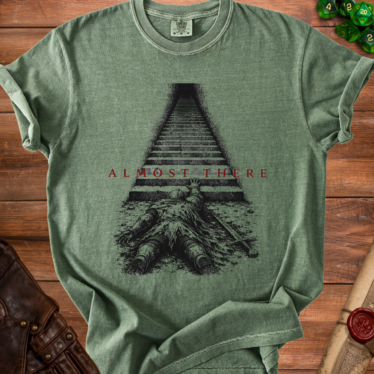 Green t-shirt with a dead knight and stairs design, text "ALMOST THERE".