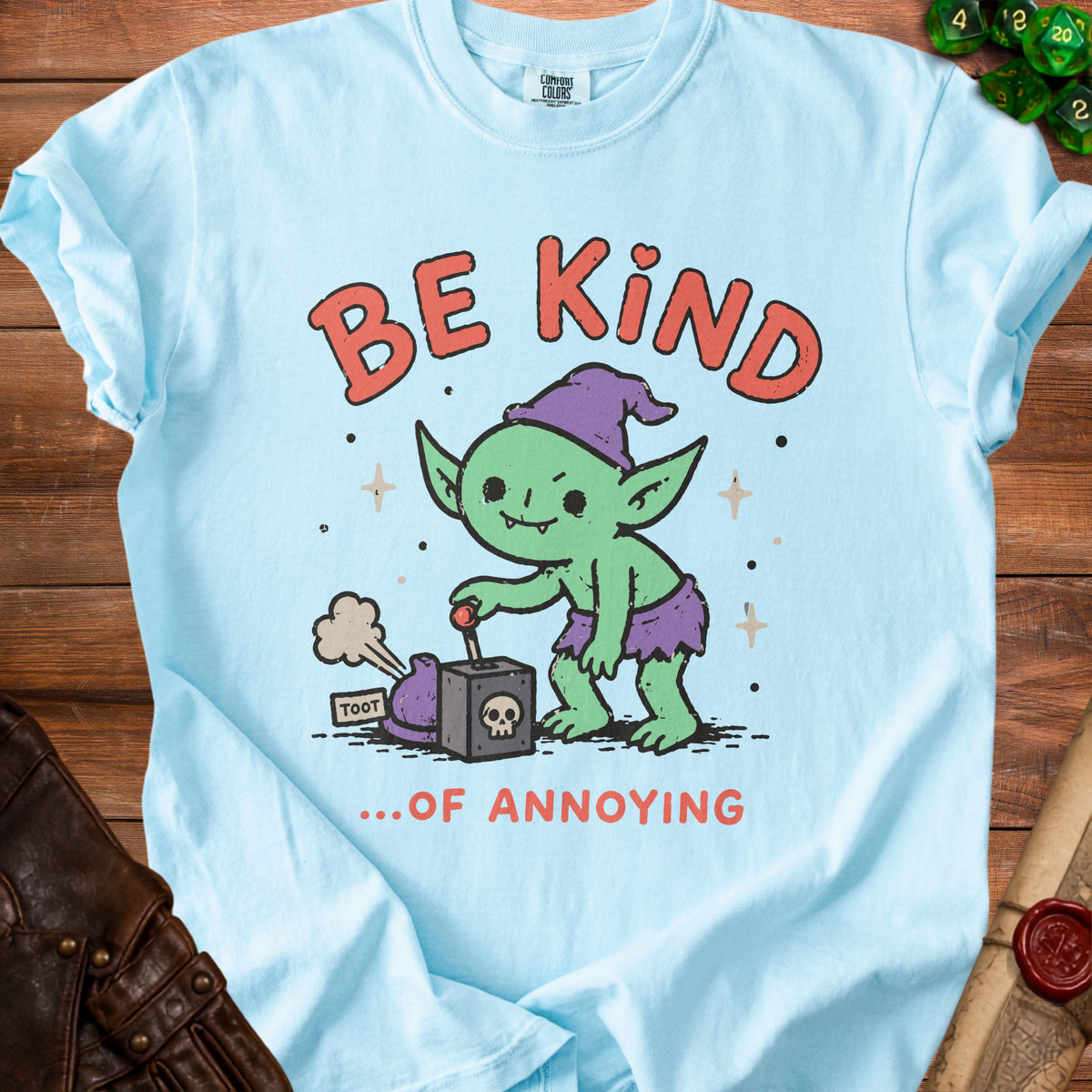 Light blue t-shirt with "BE KIND ...OF ANNOYING" text and a green goblin graphic.
