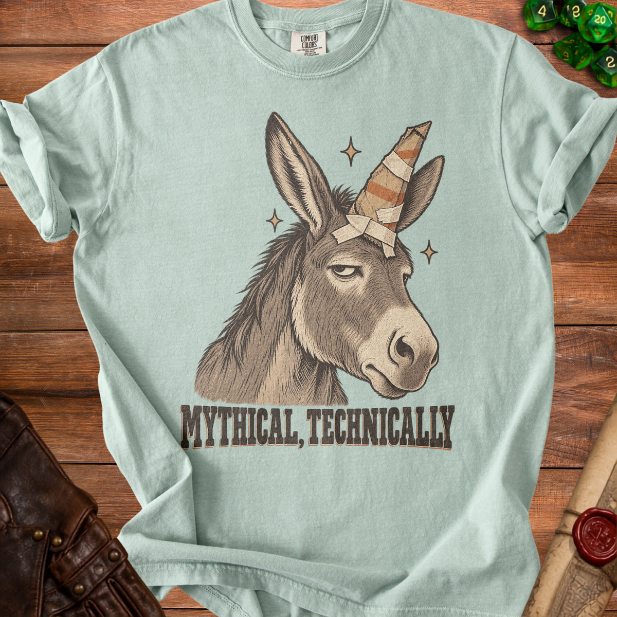 Donkey with a unicorn horn and text "MYTHICAL, TECHNICALLY" on a t-shirt.