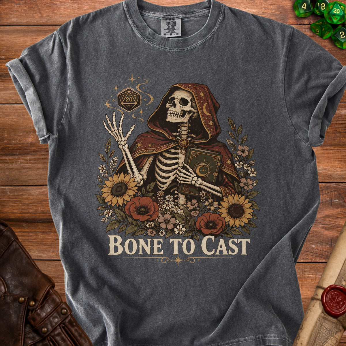 Skeleton in a hooded robe holds a book and dice with text "Bone to Cast".