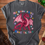 Dark grey t-shirt with a pink dragon graphic and the text "MY BOUNDARIES HAVE TEETH".