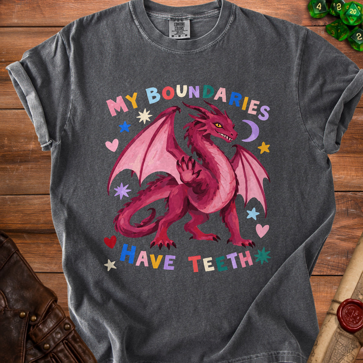 Dark grey t-shirt with a pink dragon graphic and the text "MY BOUNDARIES HAVE TEETH".