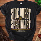 Black t-shirt with "Side Quest Specialist" and "Main Objective: Pending Indefinitely" text.