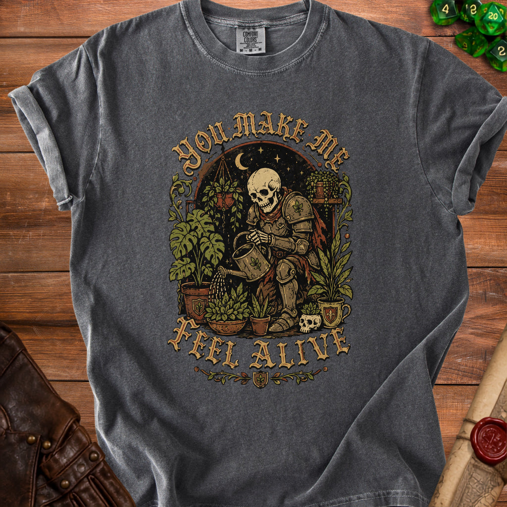 Gray t-shirt with a skeleton in armor watering plants with text "You make me feel alive."