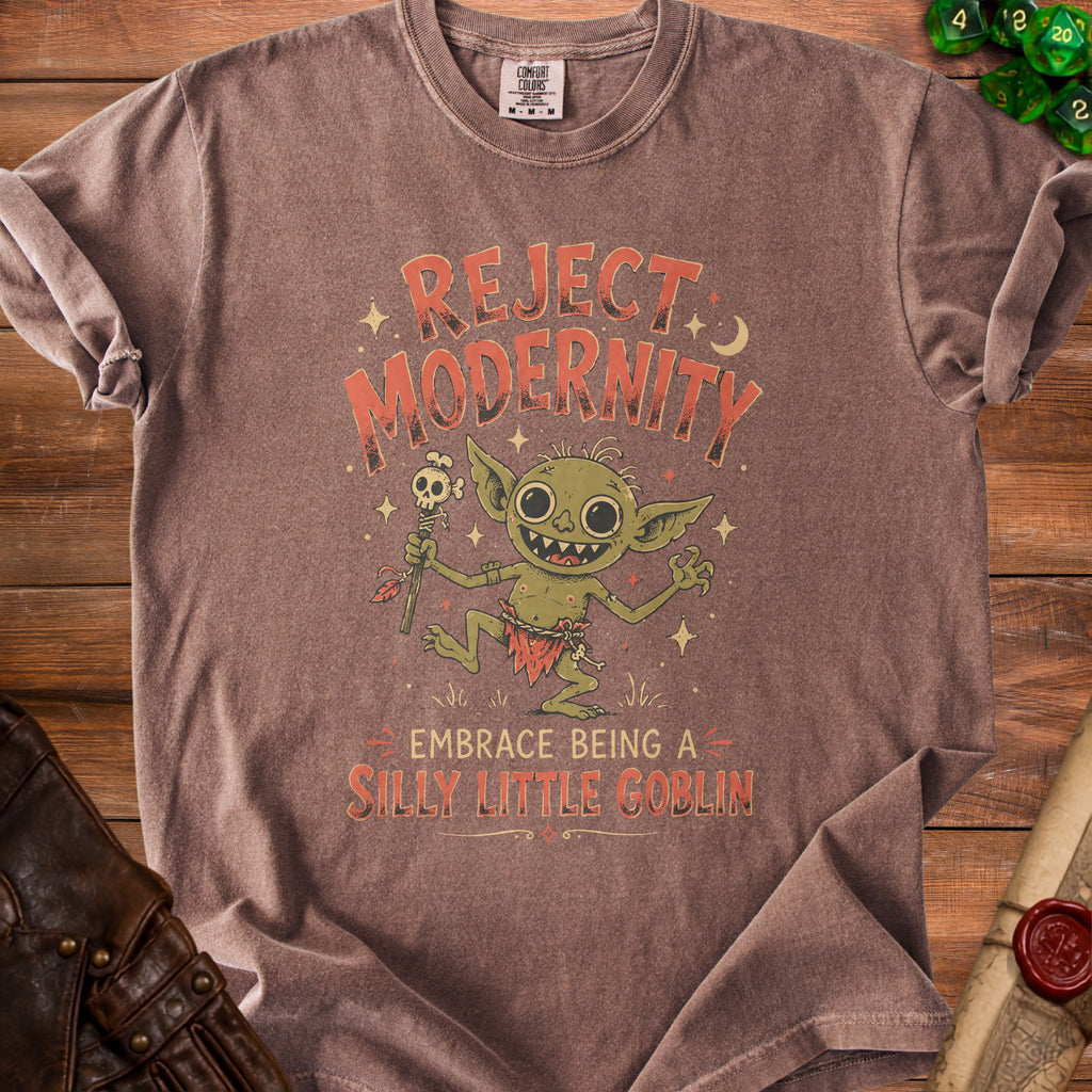 Brown t-shirt with "Reject Modernity Embrace Being A Silly Little Goblin" and a goblin graphic.