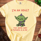Yellow t-shirt with text "I'M AN ADULT THE SAME WAY A TOMATO IS A FRUIT".