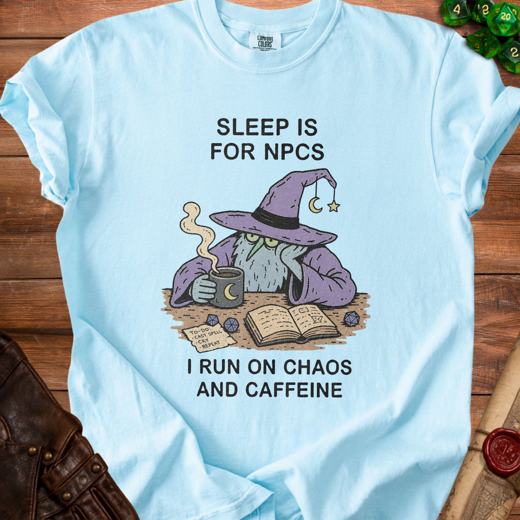 Light blue t-shirt with wizard graphic: "Sleep is for NPCs. I run on Chaos and Caffeine."