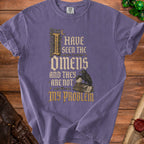 Purple t-shirt with gothic text "I HAVE SEEN THE OMENS AND THEY ARE NOT MY PROBLEM".