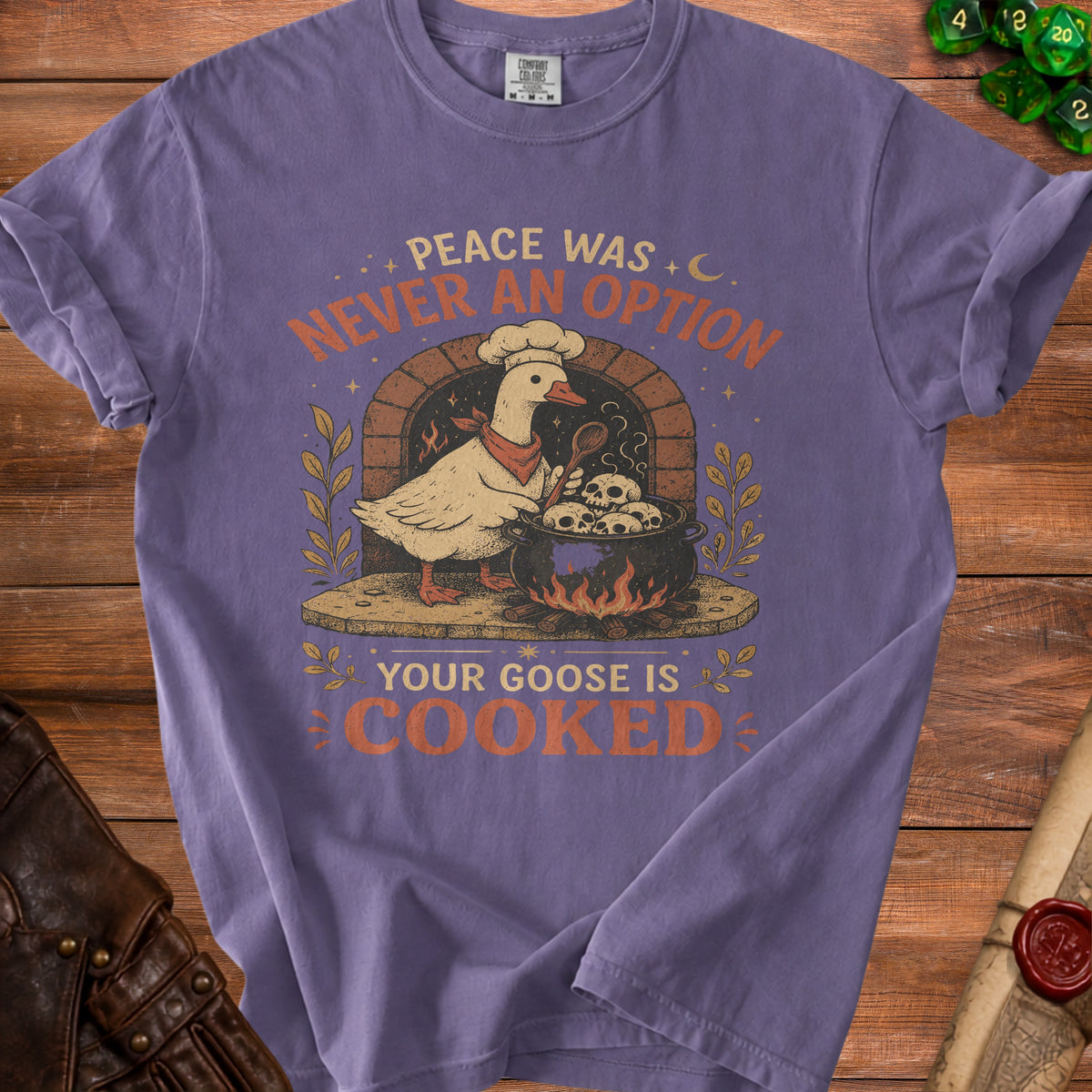 Purple t-shirt with a goose chef illustration and text "Peace was never an option".