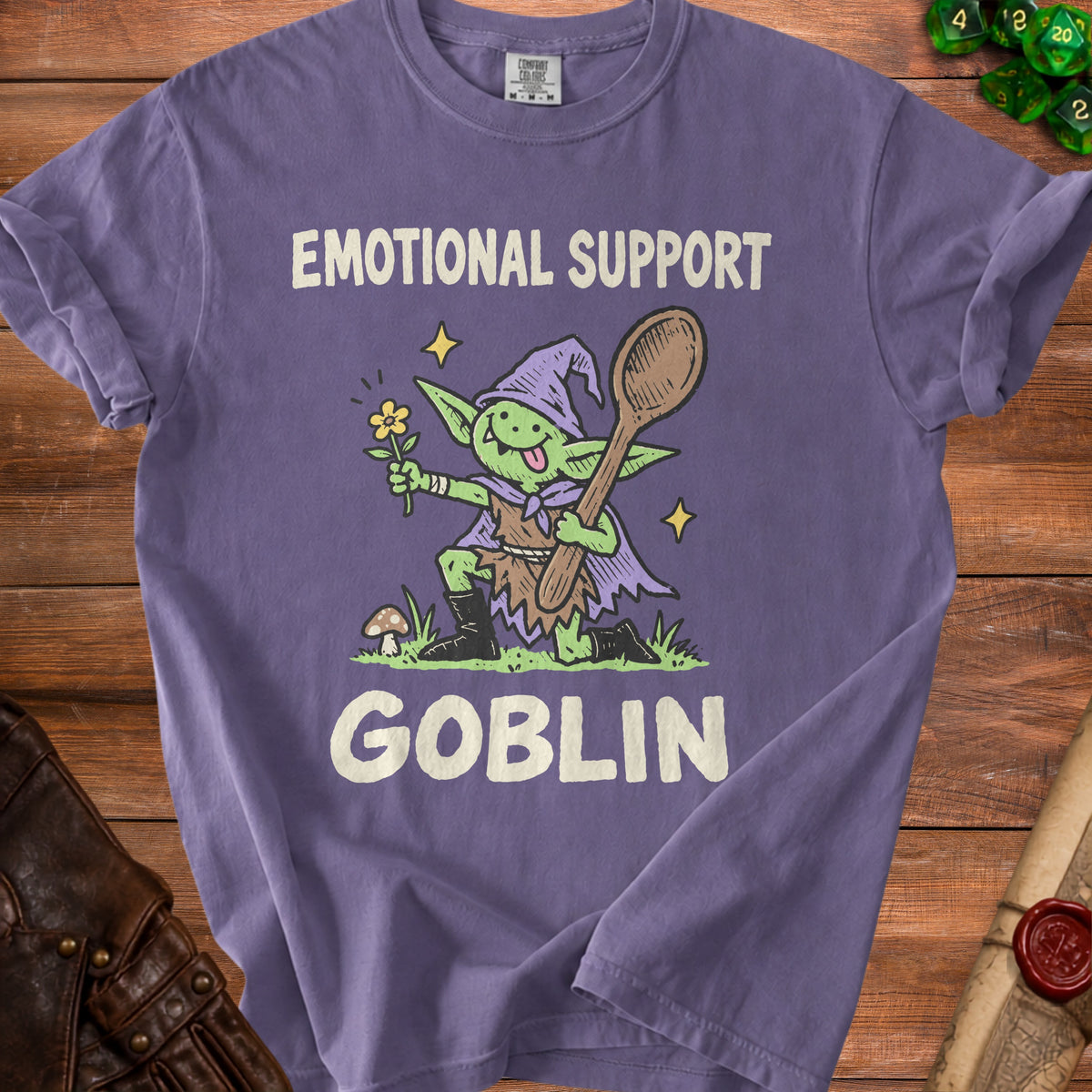 Purple t-shirt with "Emotional Support Goblin" graphic featuring a goblin holding a flower and spoon.
