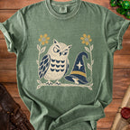 Green t-shirt with an illustrated owl and witch hat design.