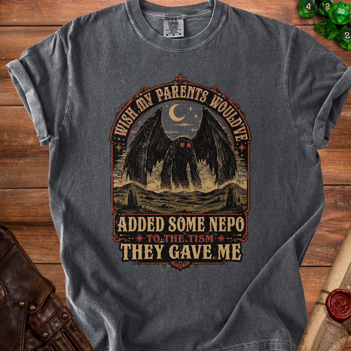 Dark gray t-shirt with "Wish my parents would've added some nepo to the tism they gave me" text and mothman graphic.