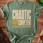 Green t-shirt with "Chaotic Competent" and a 20-sided die.