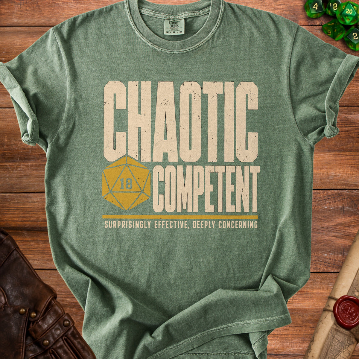 Green t-shirt with "Chaotic Competent" and a 20-sided die.