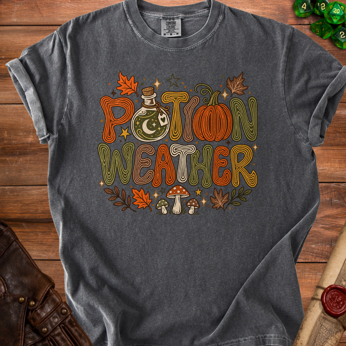 Dark gray t-shirt with "Potion Weather" text, potion bottle, pumpkin, and mushrooms.