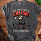 Dark grey t-shirt with a distressed graphic of a possum in a graveyard and text "How am I supposed to lollygag in these conditions?".