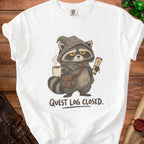 White t-shirt with raccoon wizard holding coffee and scroll, text "QUEST LOG CLOSED."