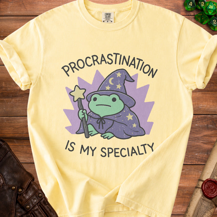 Yellow t-shirt with a wizard frog graphic and text "Procrastination is my specialty".