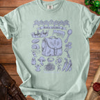 Light green t-shirt with a blue sketch of "Goblin valuables" including a crown, bag, and various trinkets.