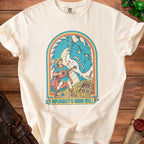 Cream t-shirt with illustration of a bard playing lute before a dragon, with text "DIPLOMACY IS GOING WELL".