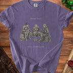 Purple t-shirt with illustration of three adventurers around a campfire. "Short Rest Long Complaints" text.