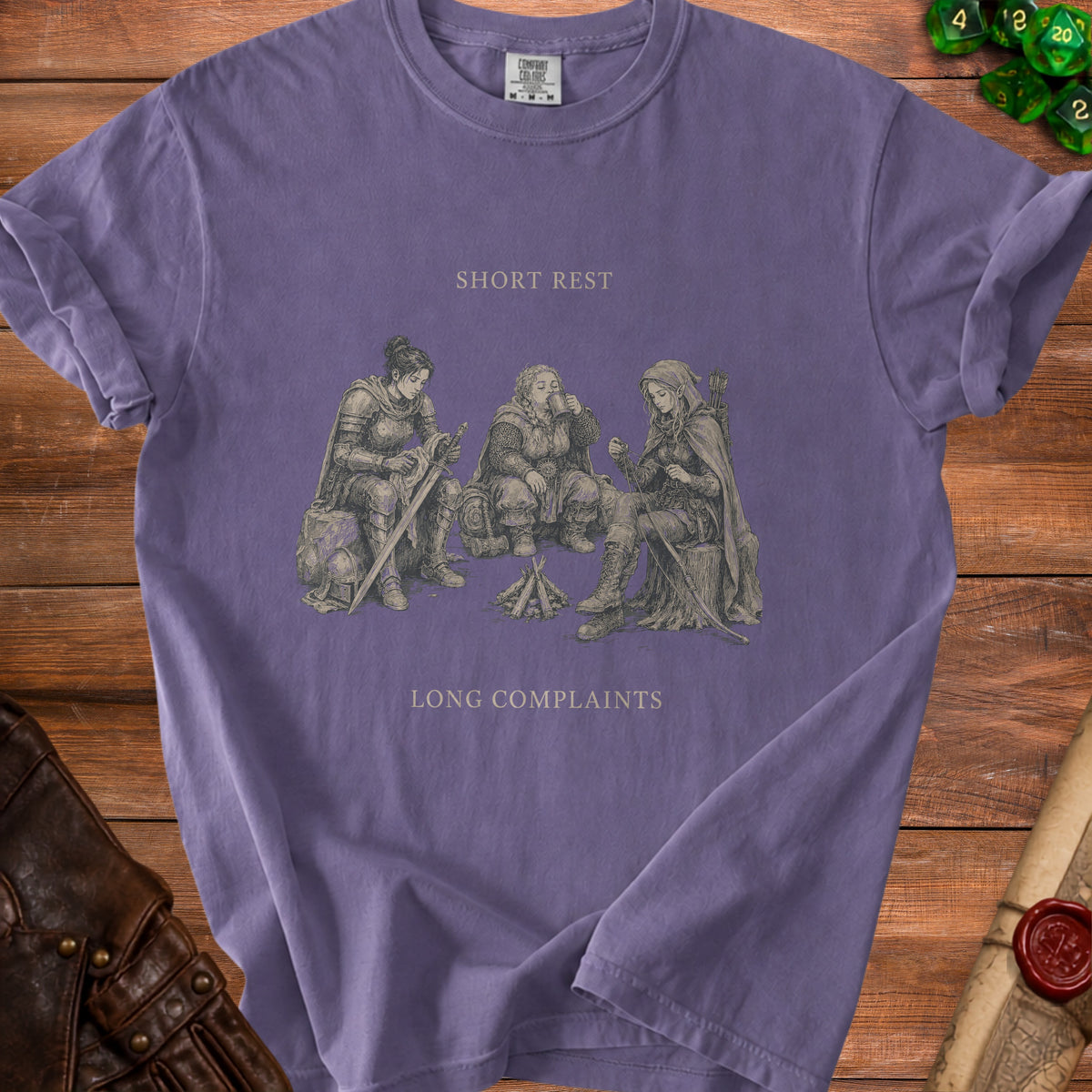 Purple t-shirt with illustration of three adventurers around a campfire. "Short Rest Long Complaints" text.