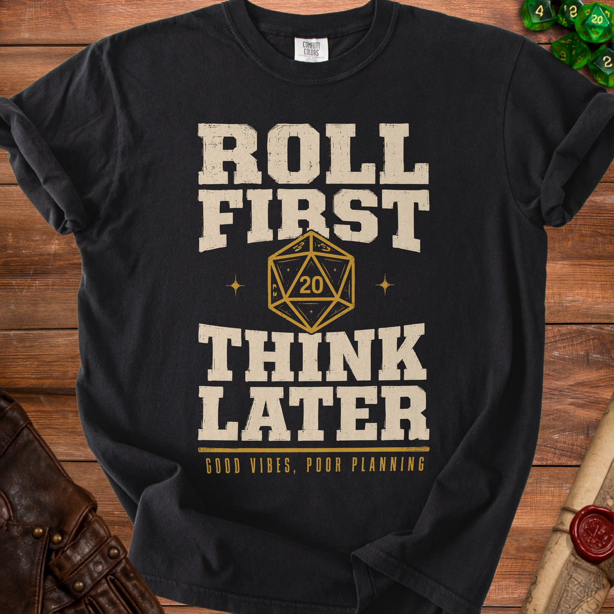 Black t-shirt with "ROLL FIRST THINK LATER GOOD VIBES, POOR PLANNING" and a twenty-sided die.