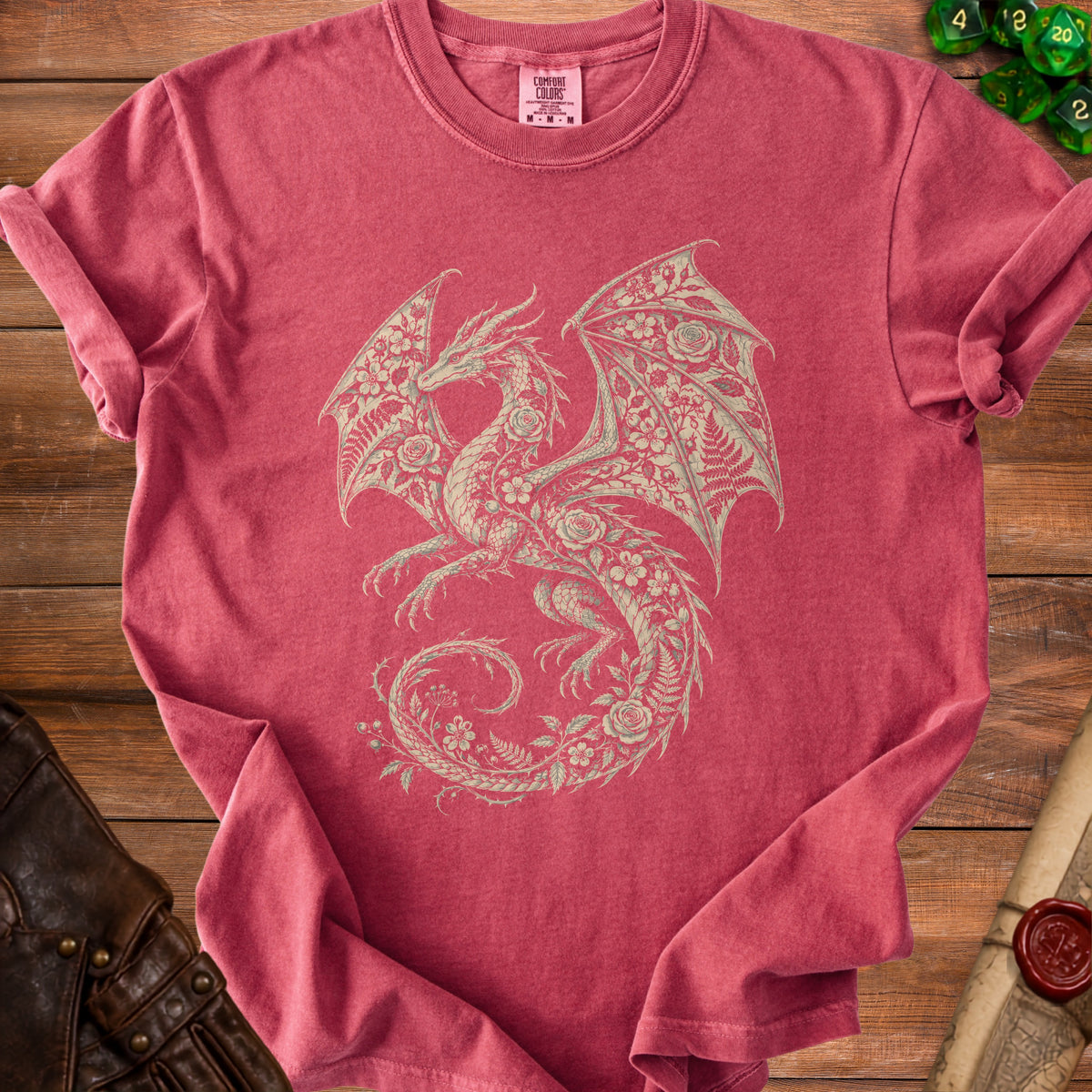 Red t-shirt with a cream-colored dragon design made of flowers and leaves.