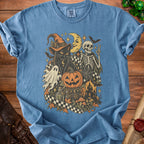 Blue t-shirt with a vintage Halloween graphic featuring a black cat, skeleton, and spooky elements.