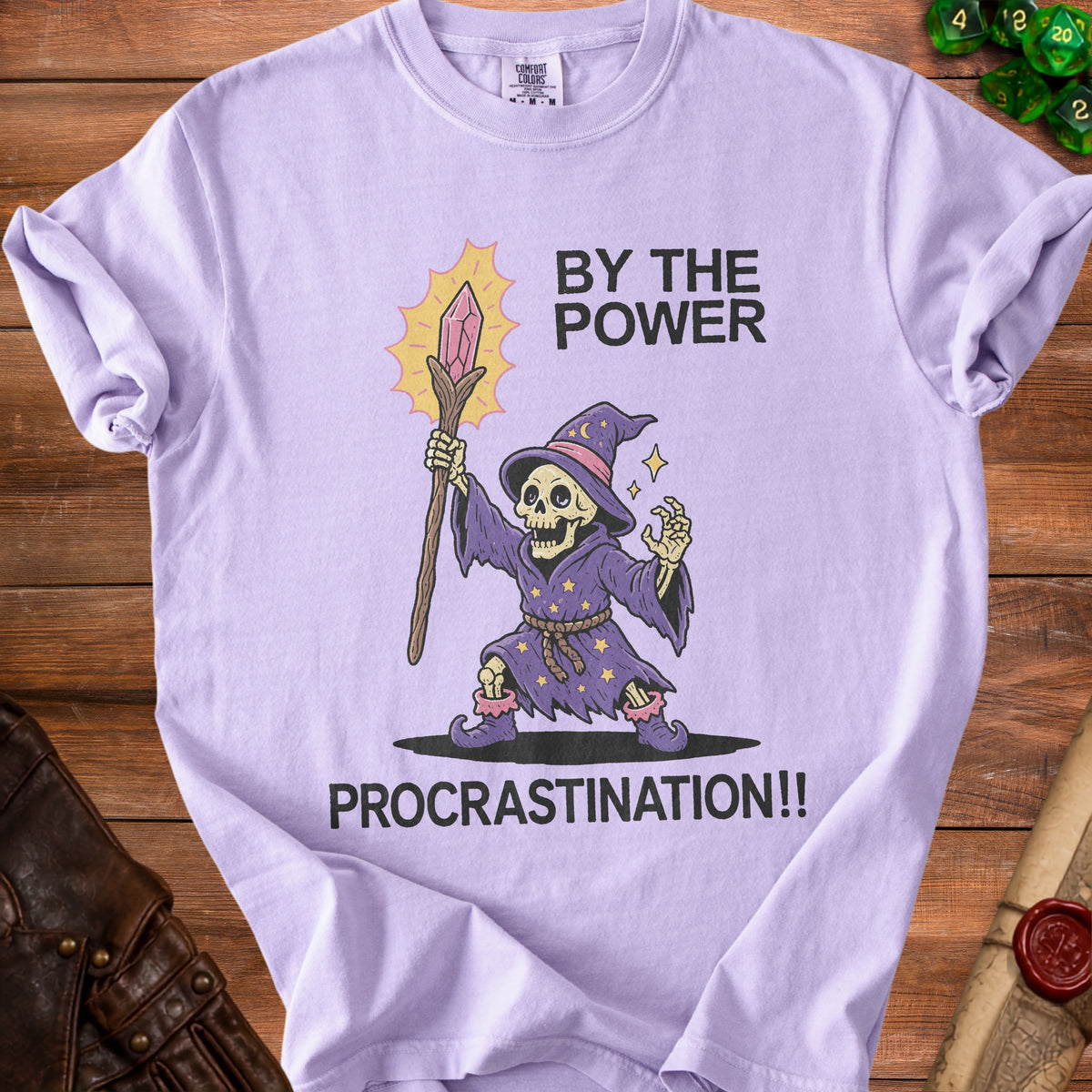 Purple t-shirt with skeleton wizard graphic and text "BY THE POWER PROCRASTINATION!!".