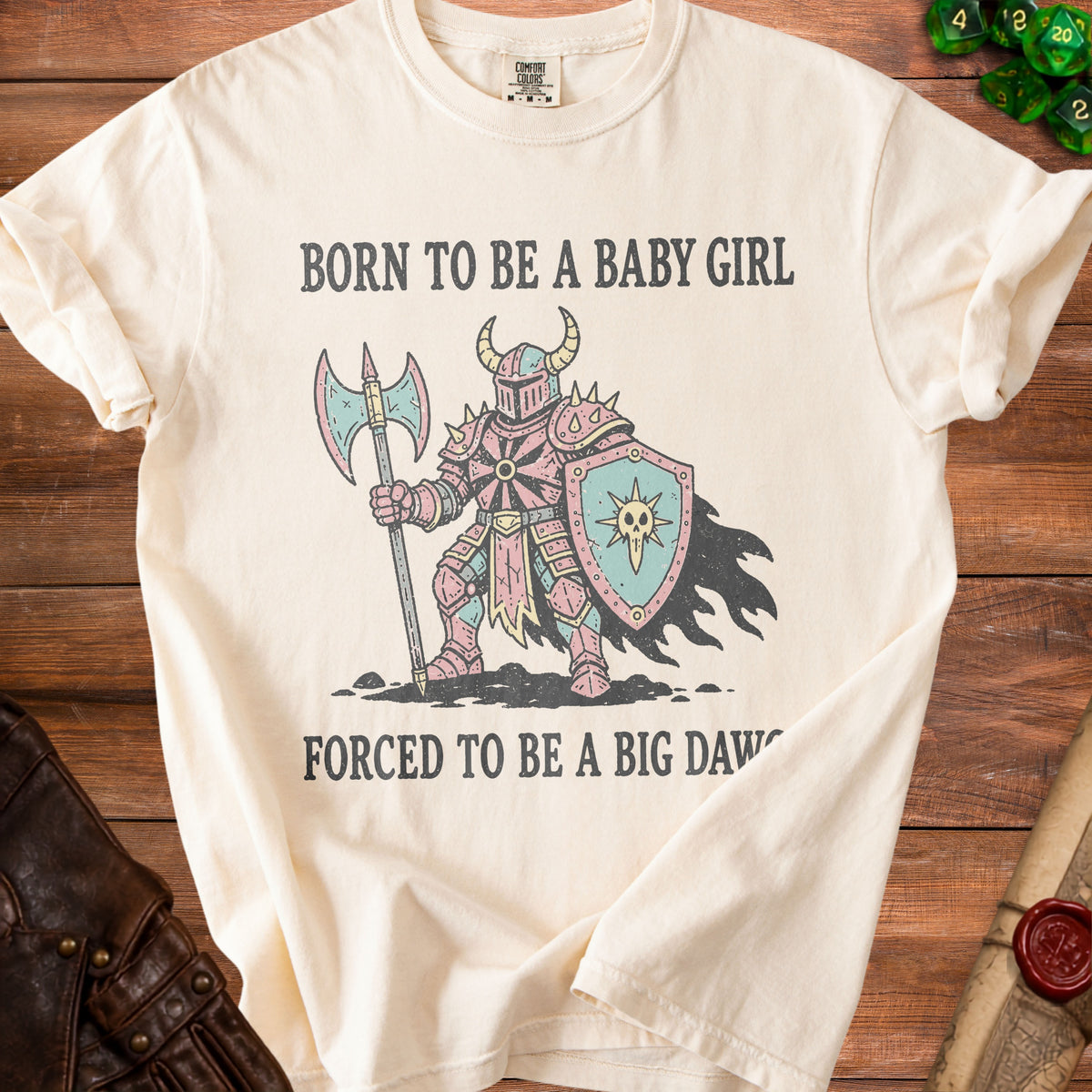 Cream t-shirt with knight graphic and text "BORN TO BE A BABY GIRL FORCED TO BE A BIG DAWG".