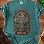 T-shirt graphic: skeleton dancing in mountains, with text "The Sound of Existential Dread".