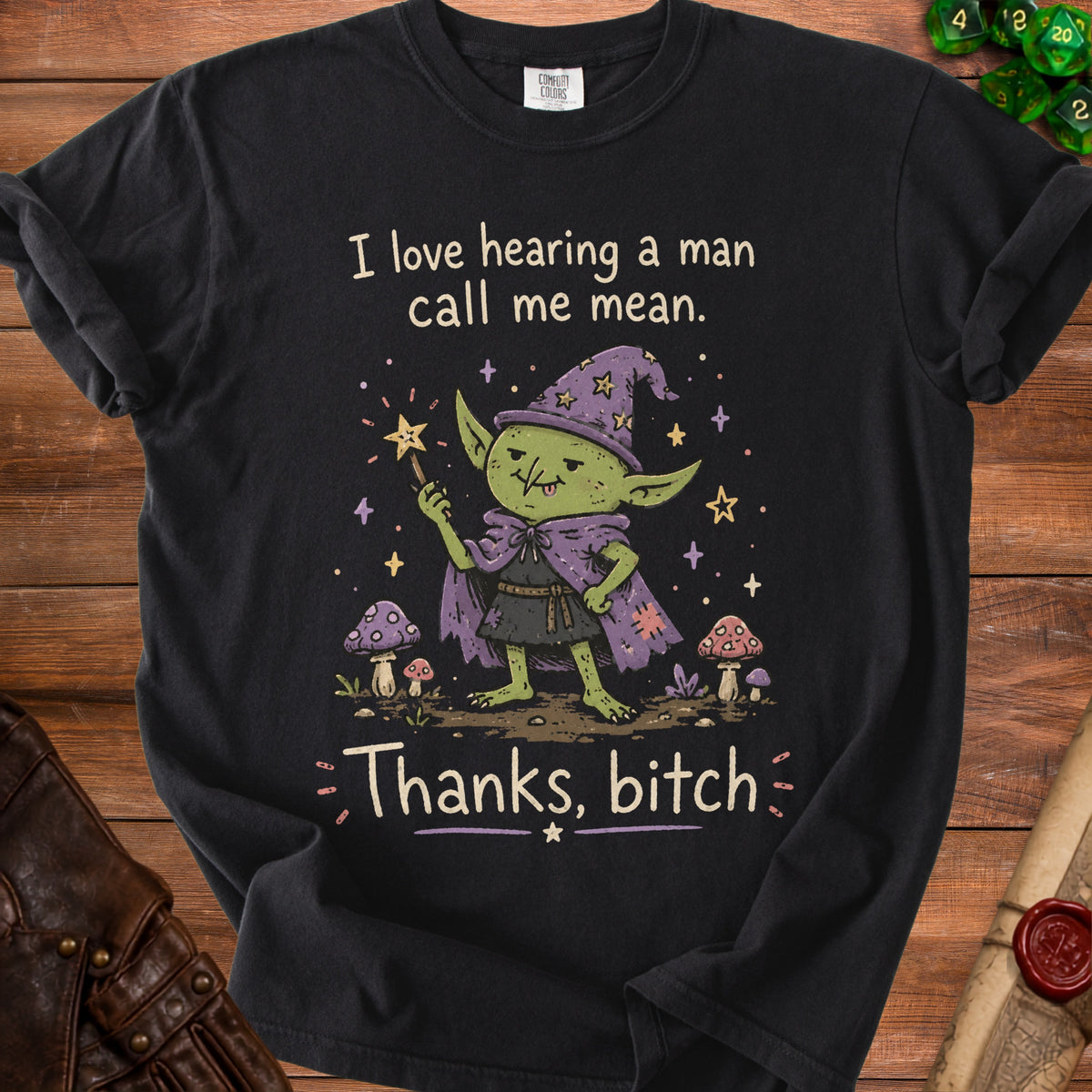Black t-shirt with a goblin wizard illustration and text "I love hearing a man call me mean. Thanks, bitch."