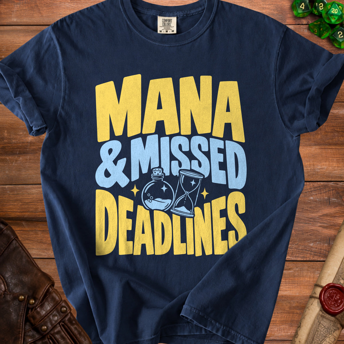 Navy t-shirt with yellow and blue text: "MANA & MISSED DEADLINES" and graphic.