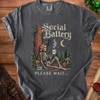 Skeleton with coffee mug reading 0% Social Battery, with text "PLEASE WAIT..."